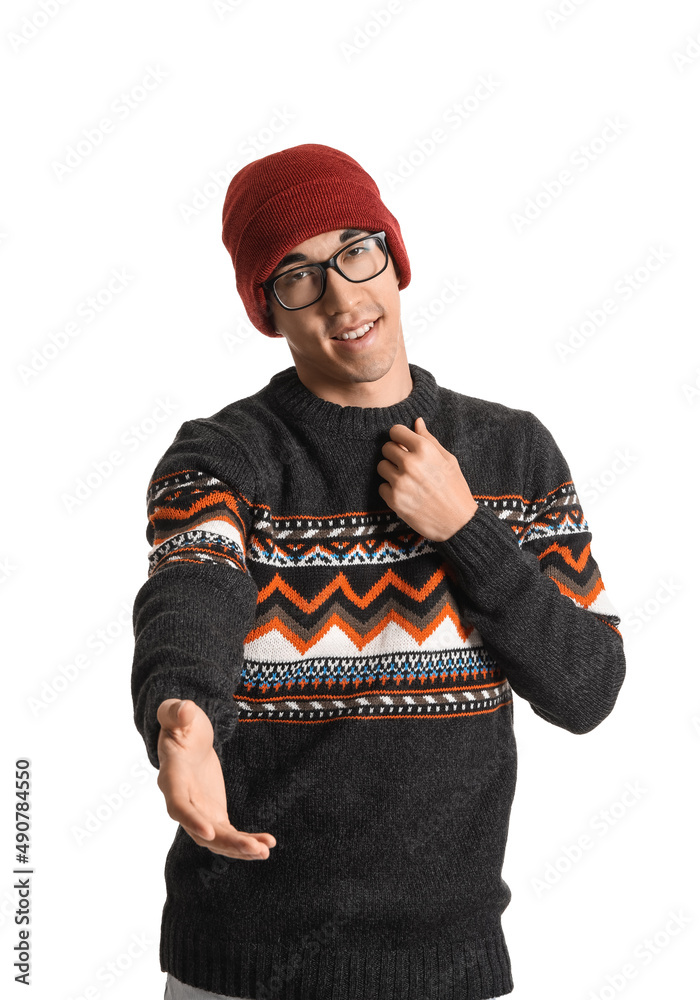 Handsome Asian man in knitted sweater on white background