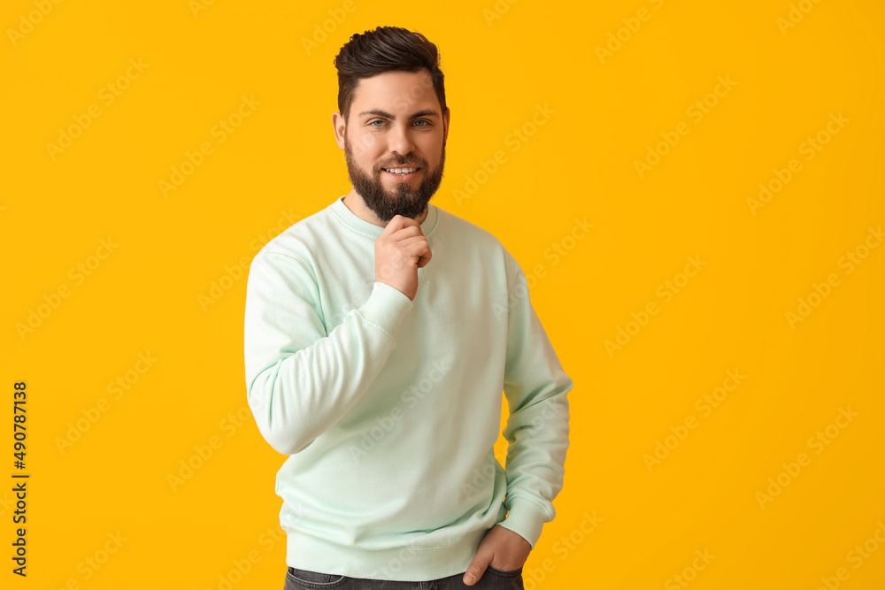 Stylish bearded man on yellow background