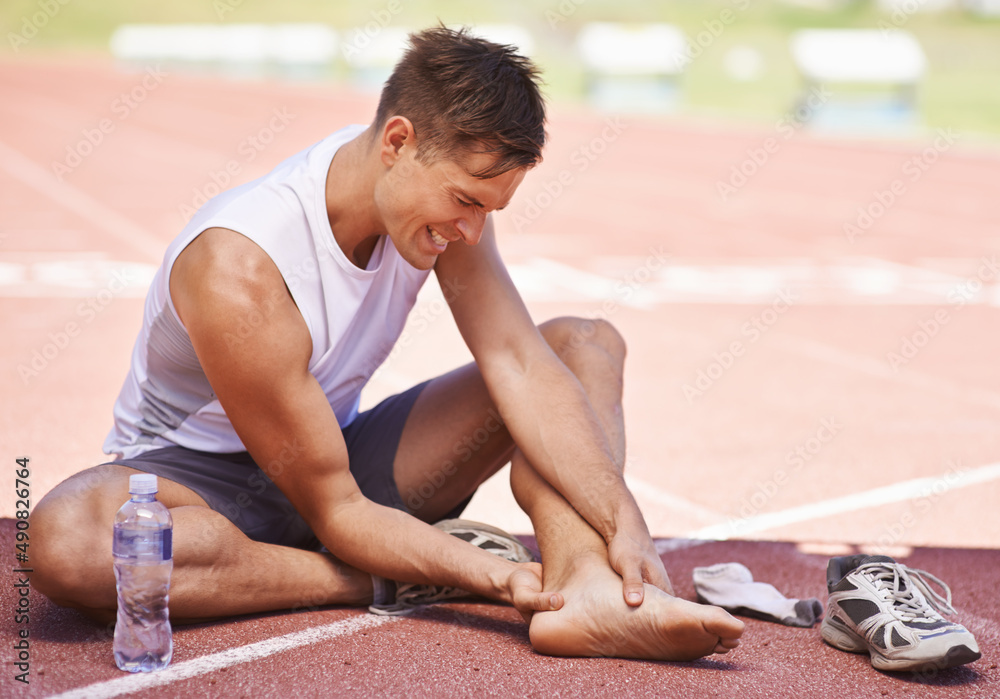 Youve got to break down before you can build up. Shot of an athlete feeling the pain of an ankle inj