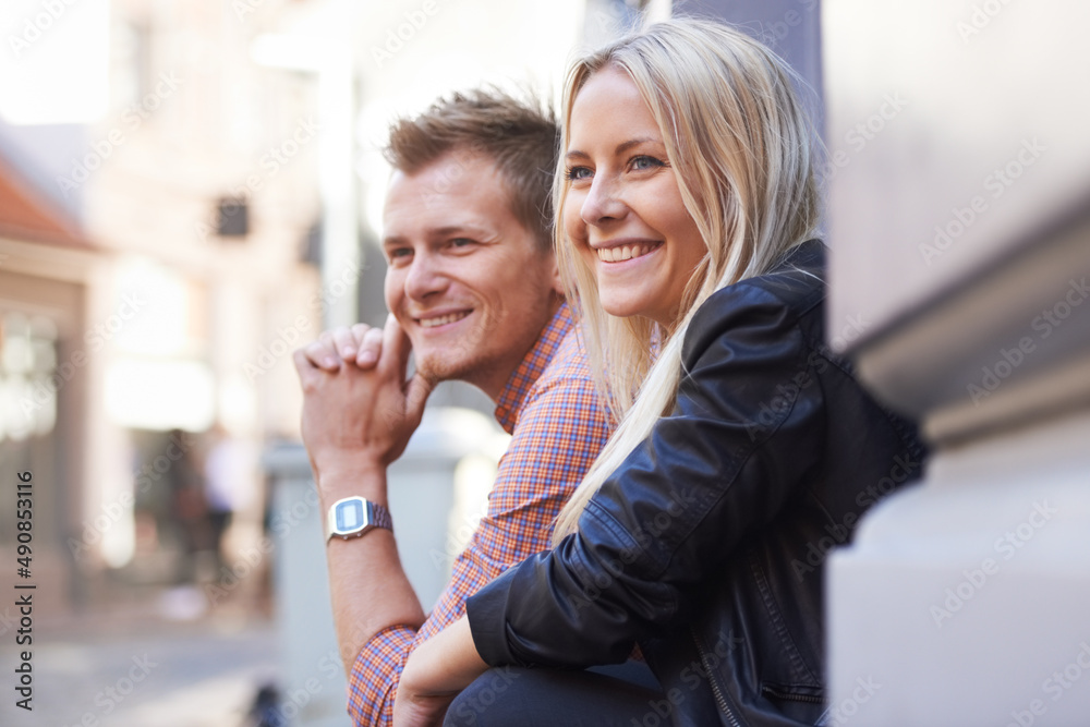 This neighborhood such an awesome vibe. A cute young couple sitting on their doorstep and looking ou