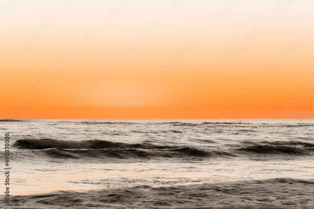 Beautiful shot of a beach in the background of seascape in the sunset.