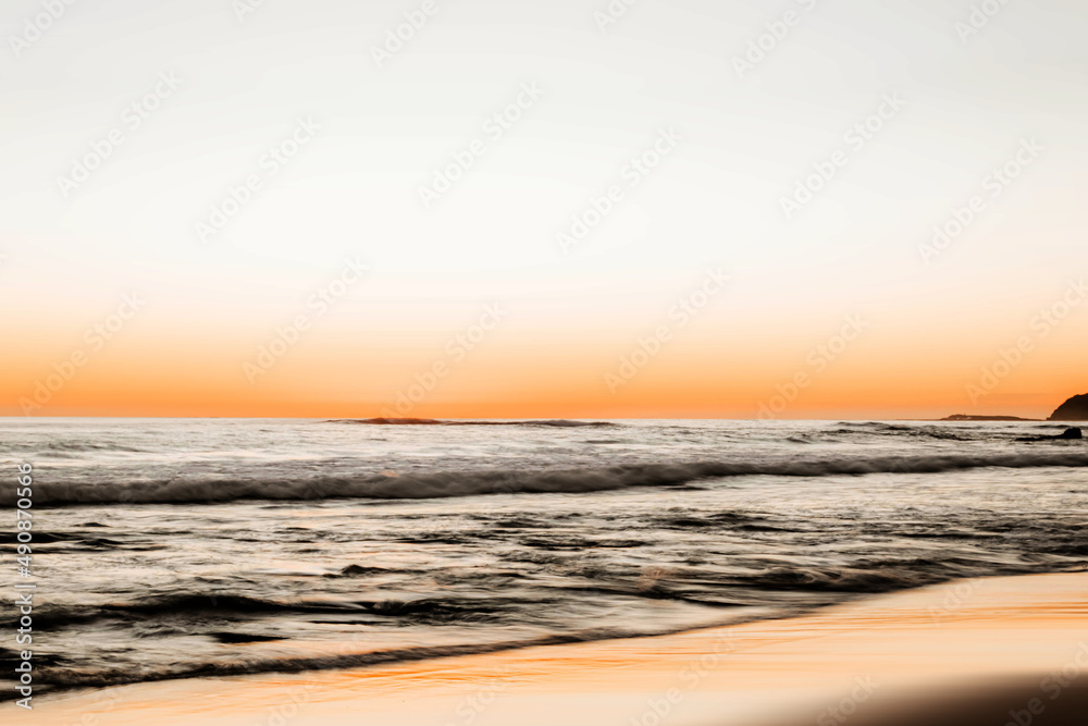 Beautiful shot of a beach in the background of seascape in the sunset.