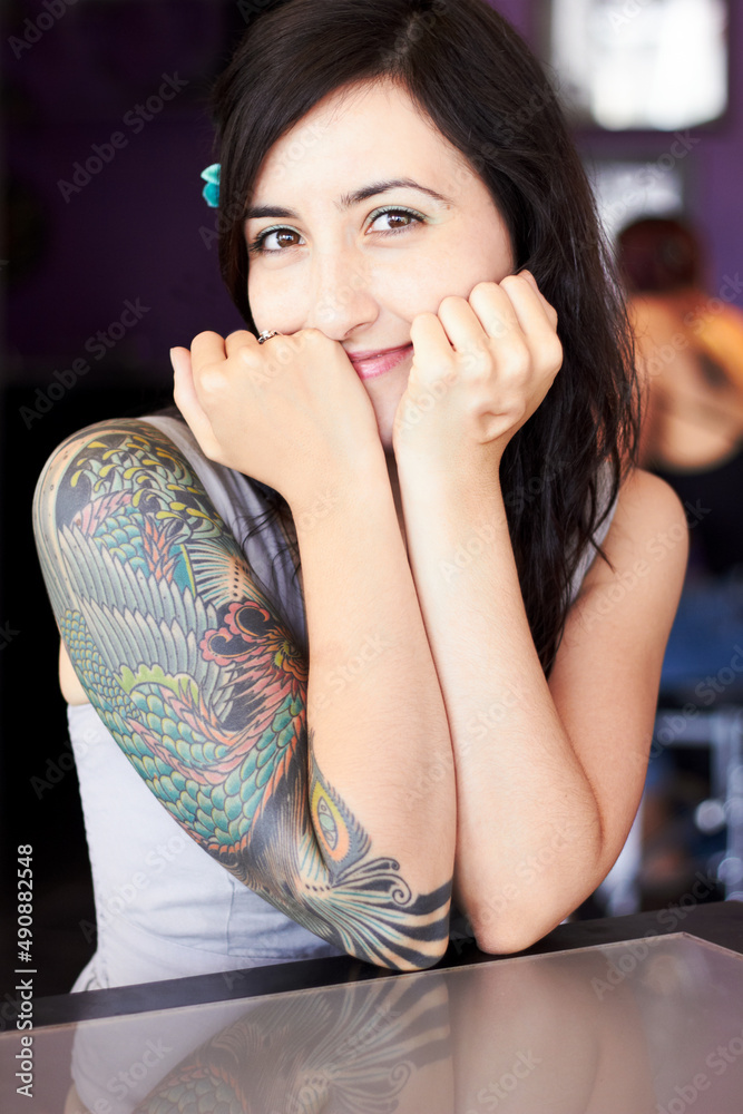 Showcasing her individual style. Portrait of a female tattoo artist showing off her half-sleeve tatt