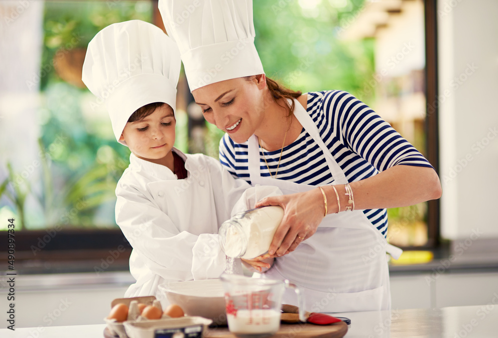 Keep calm and bake on. Shot of a mother and her son baking in the kitchen.