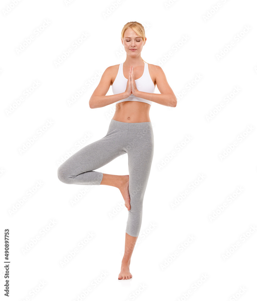 She meditates before and after every workout. Full-length shot of an attractive young woman meditati