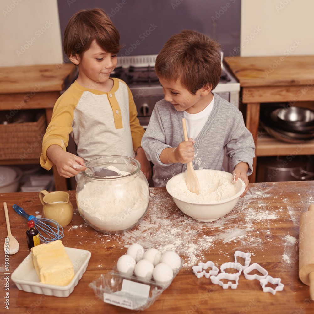 Im mixing this..what are you doing now. Shot of al little boys baking in a kitchen.