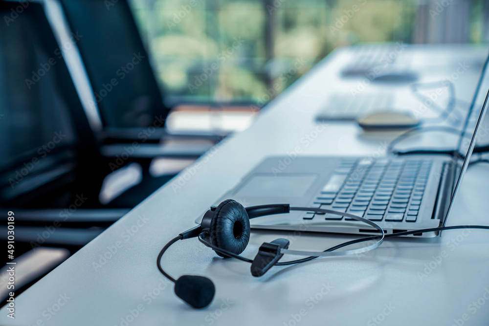 Headset and customer support equipment at call center ready for actively service . Corporate busines