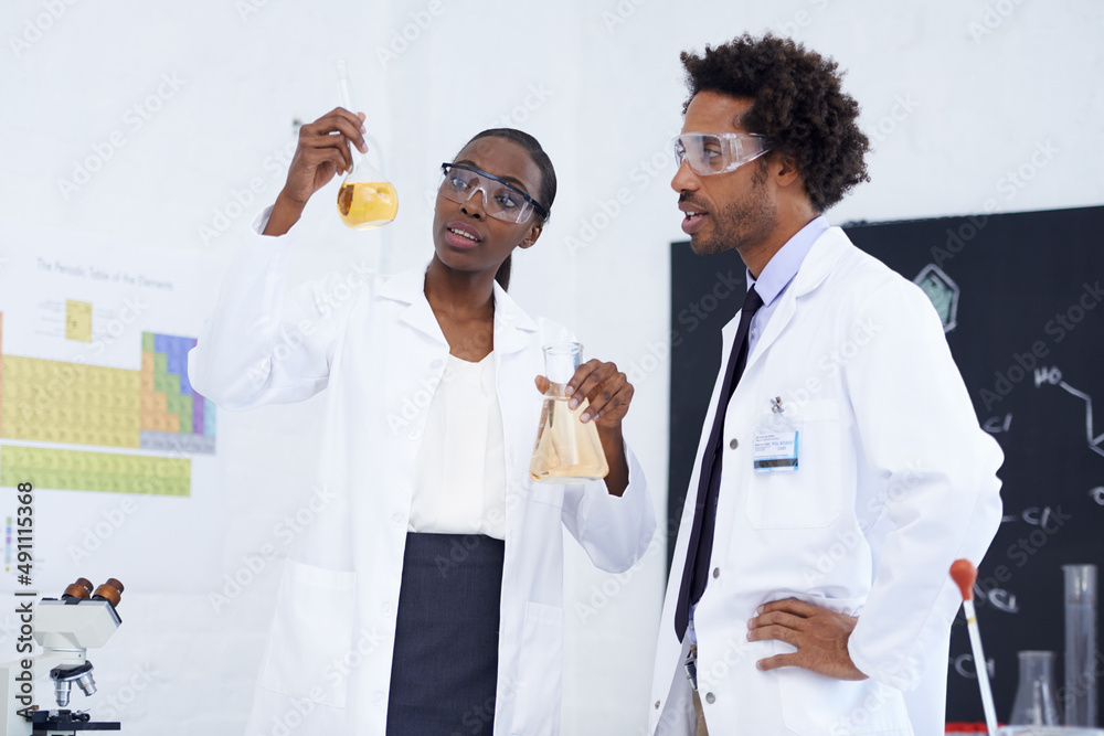 Making science breakthroughs. Shot of two scientists conducting an experiment in their lab.