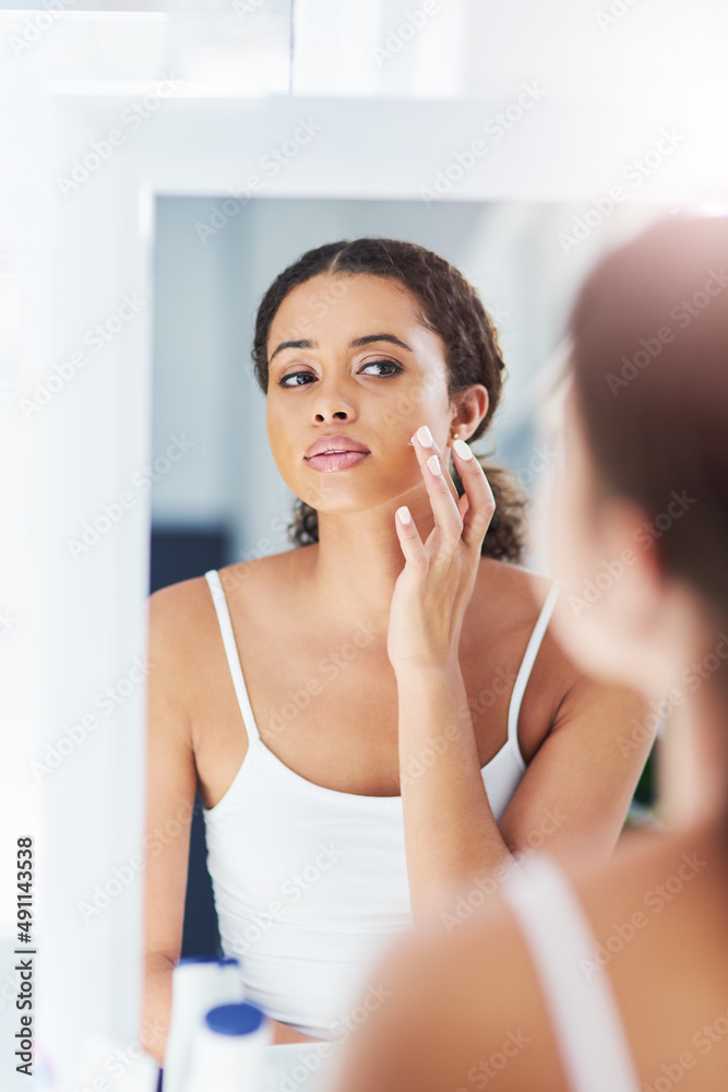 This product gives me instant results. Cropped shot of an attractive young woman applying moisturize