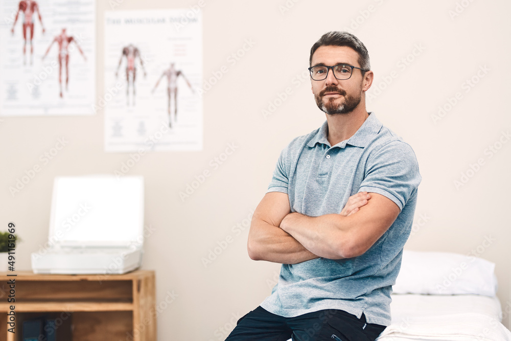 Helping you heal is my job. Portrait of a handsome mature male physiotherapist posing with his arms 