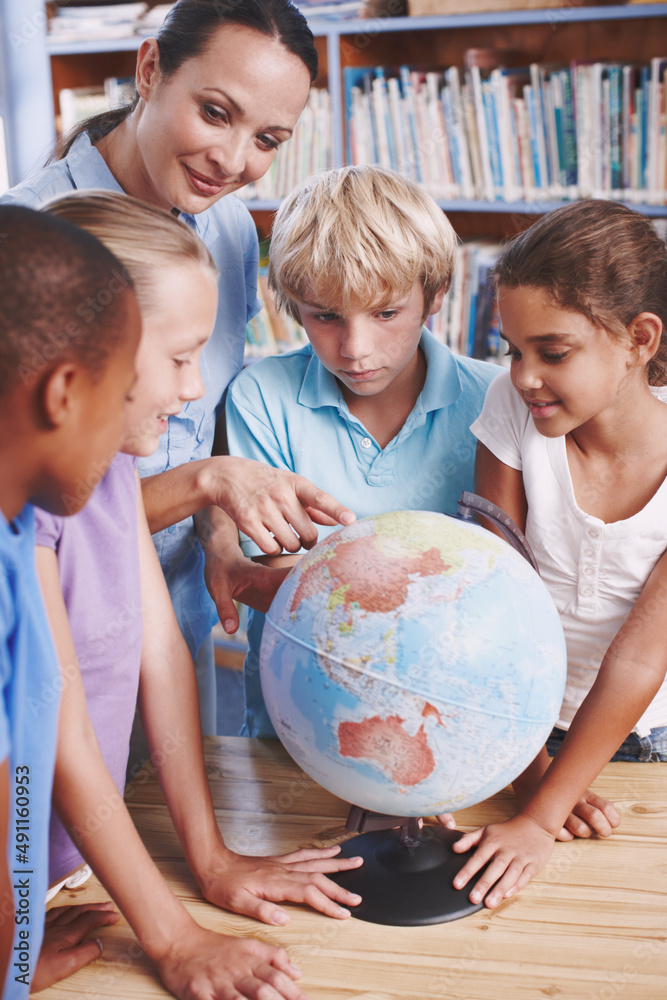 Can you tell me where this is. A group of schoolchildren learning about the world with their geograp