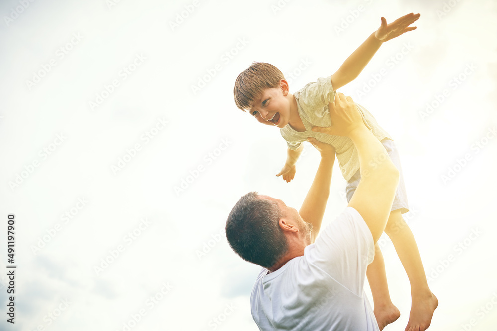 You getting bigger everyday but youre still my little boy. Cropped shot of a father tossing his ador