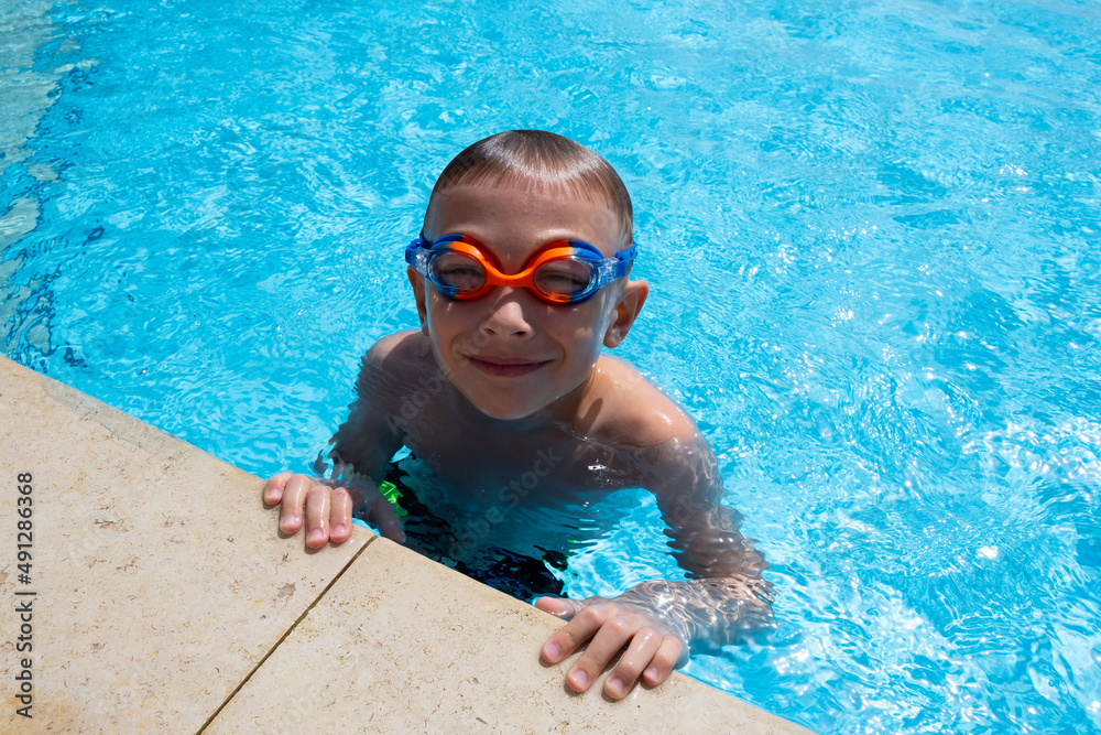 little boy swimming in the pool