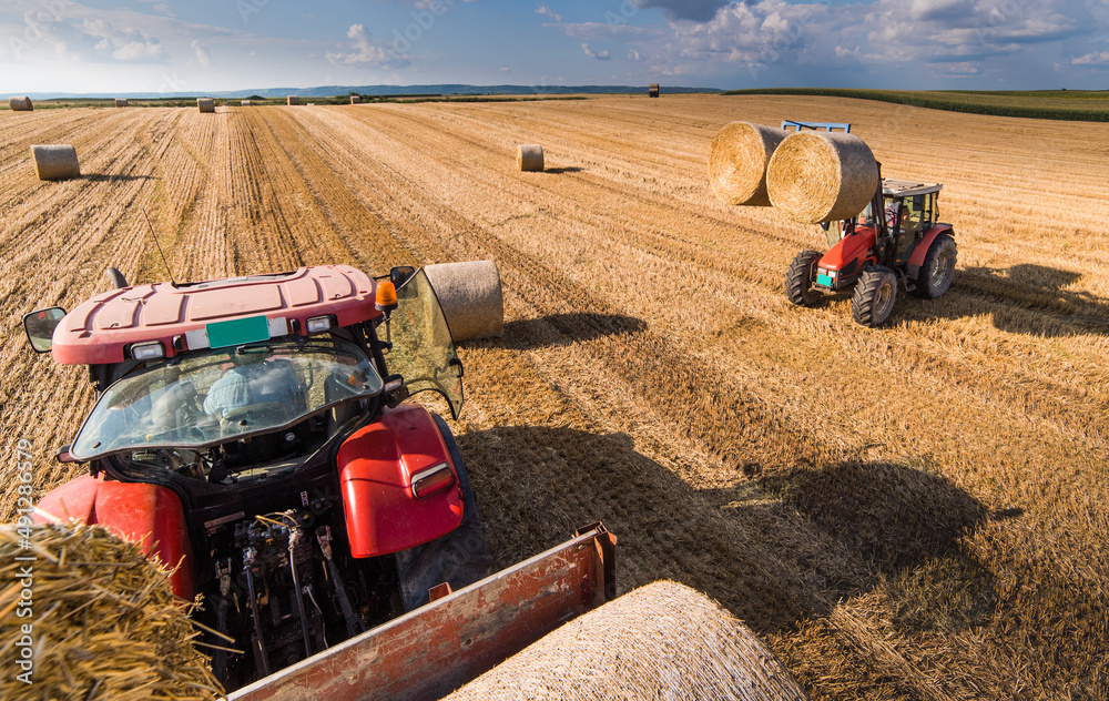 Bale on tractor trailer in farm field