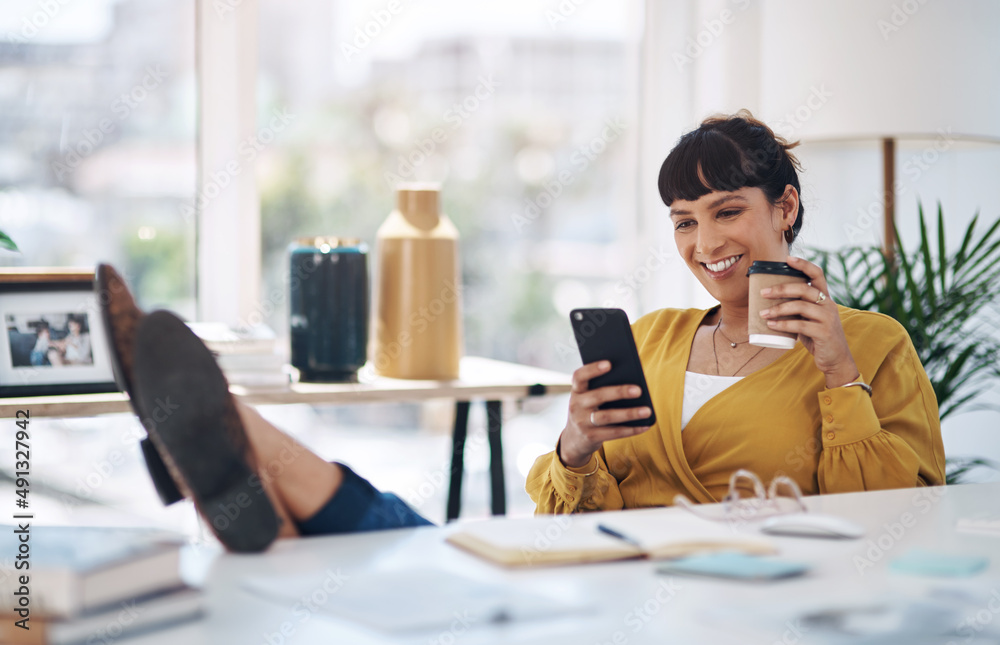 Coffee and technology go hand in hand. Cropped shot of an attractive young businesswoman sitting wit