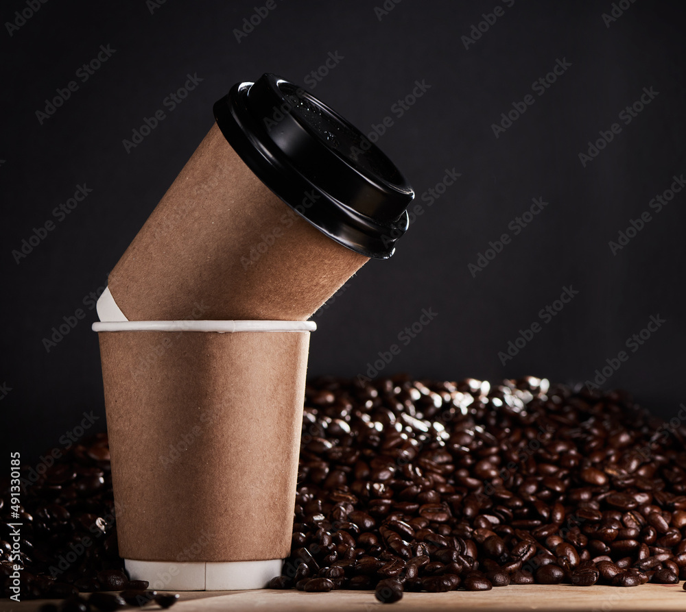 Stay grounded, give warmth and share a latte love. Closeup shot of two paper cups with coffee beans 