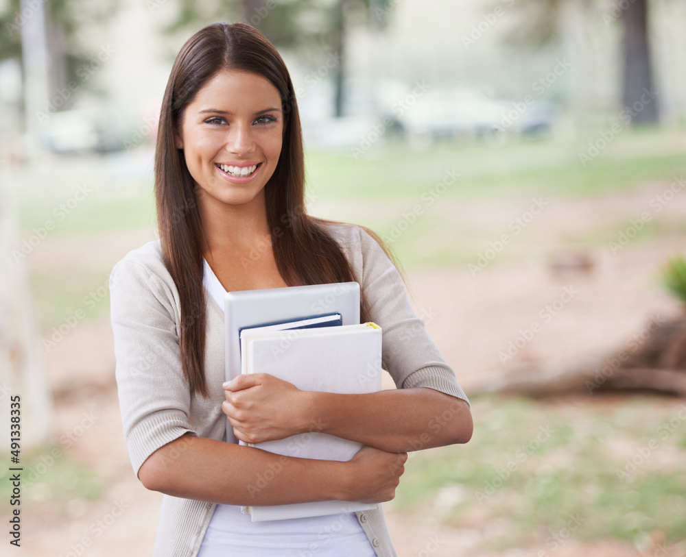 Im ready for my class today. A beautiful young student standing outside holding her books.