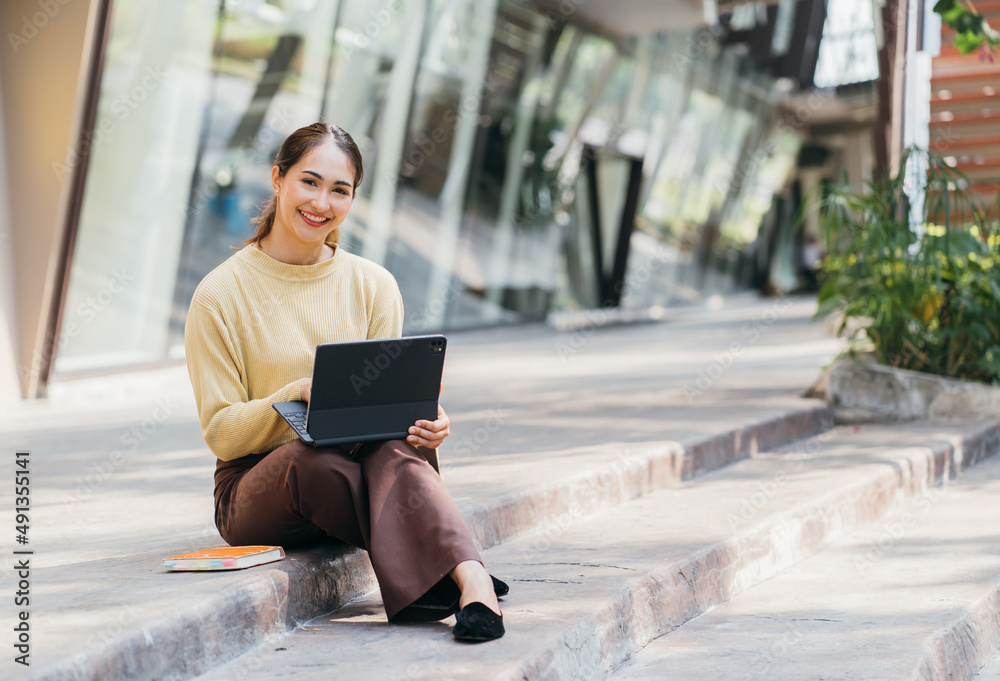 Student girl working with a digital tablet in a city, back to school concept.