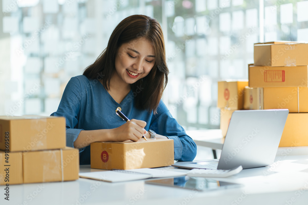 Two asian women with startup small business entrepreneur freelance working at home. checking product