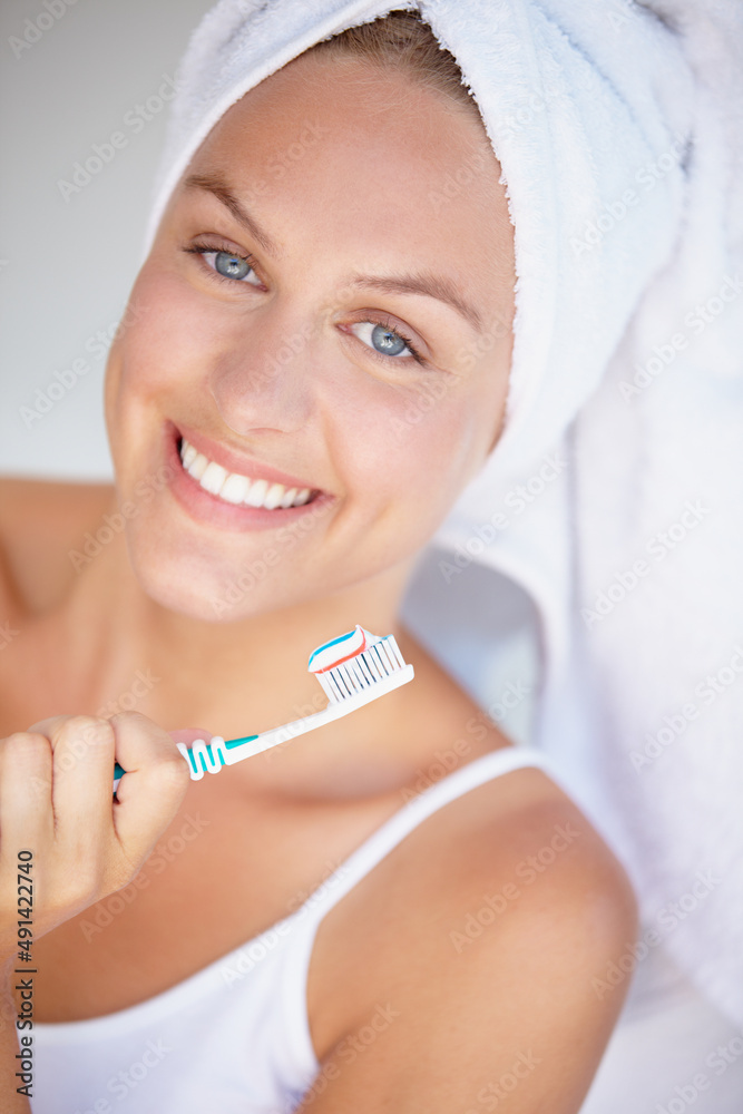 Maintaining the perfect smile. Shot of a beautiful woman brushing her teeth.