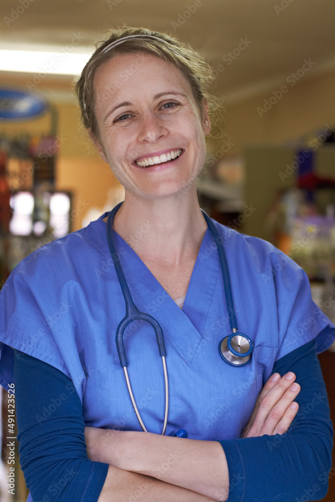 Loving the work I do. Portrait of a happy veterinarian standing with her arms folded.