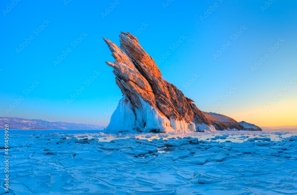 Ogoy island on winter Baikal lake with transparent cracked blue ice at sunrise - Baikal, Siberia, Ru