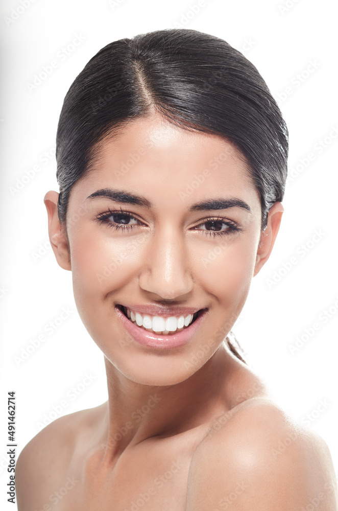 Fresh beauty with a truly engaging smile. Studio portrait of a beautiful young woman smiling at the 