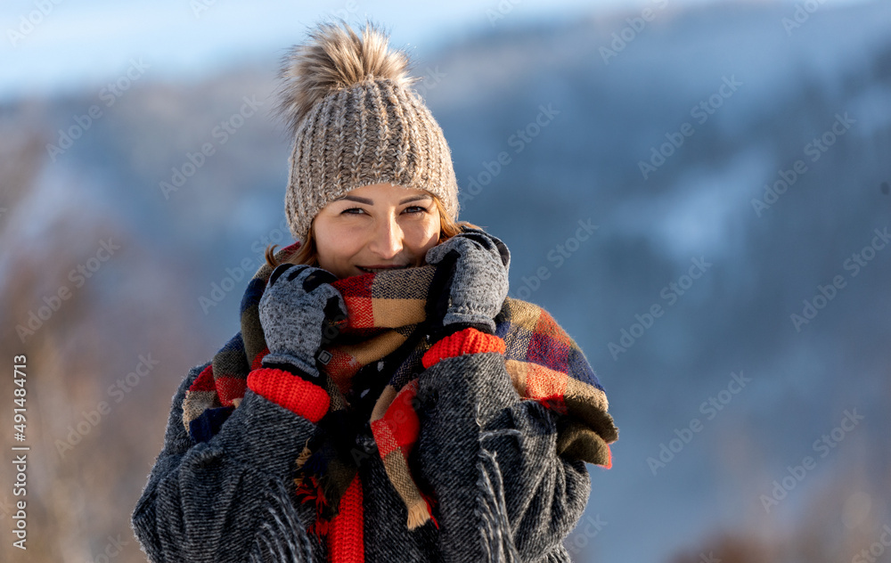 Happy girl in winter clothes portrait snowy outdoor during sunny day