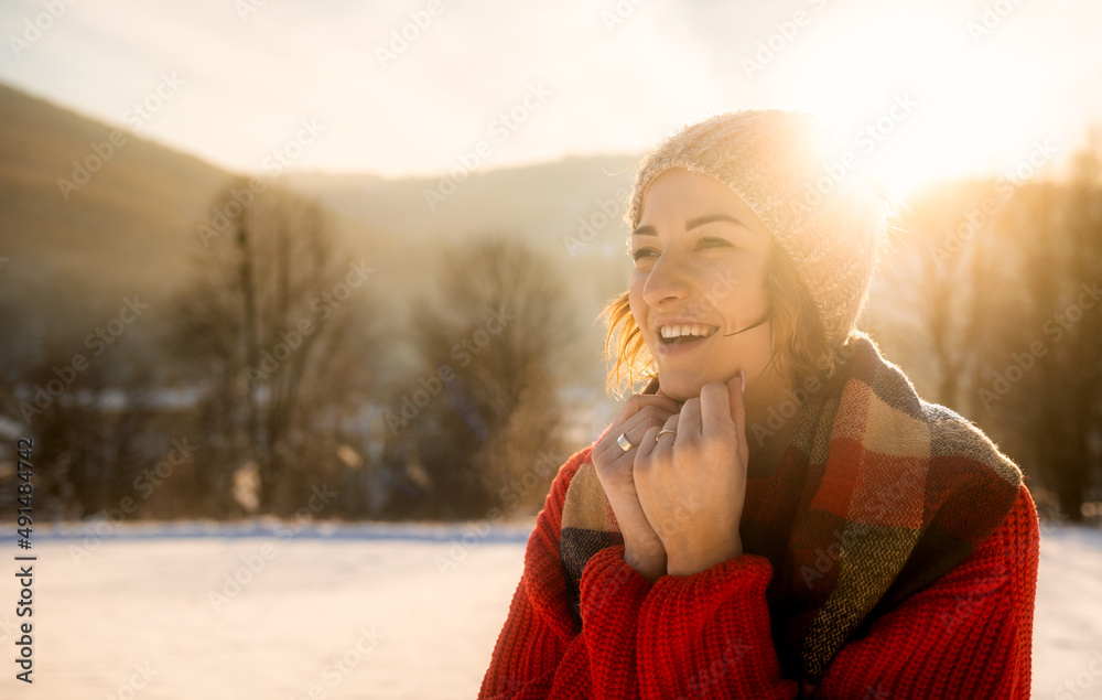 Happy girl in winter clothes portrait snowy outdoor during sunny day