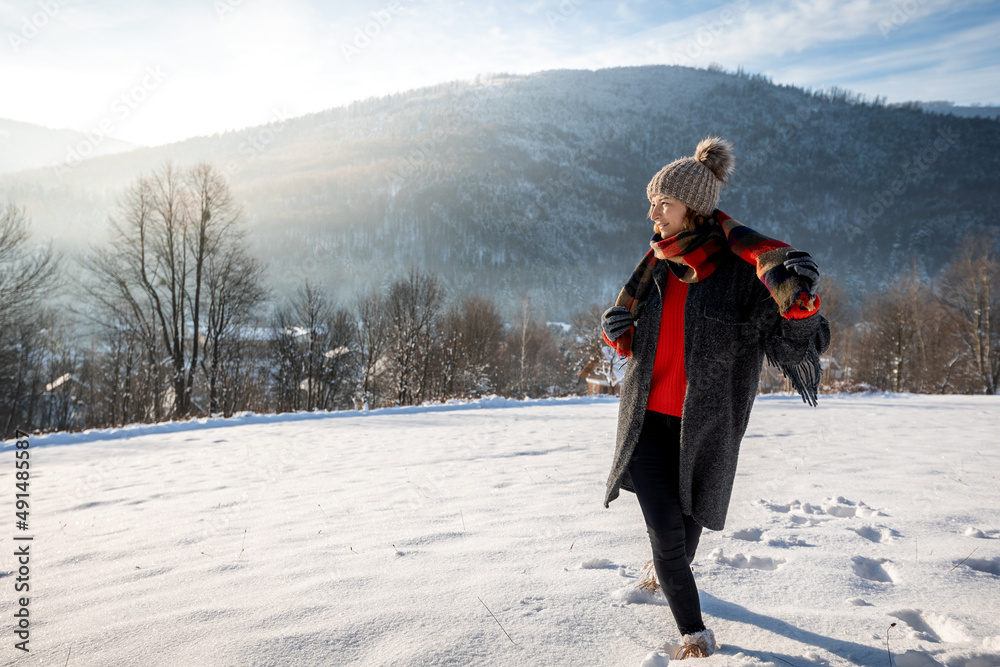 Wintertime smiling woman among snowy landscape