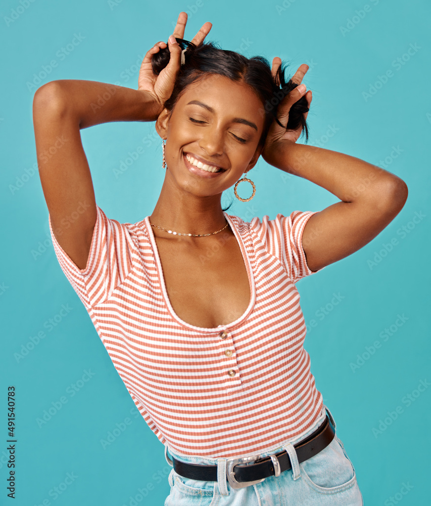 Always be your weirdest self. Shot of a young woman posing shot against a studio background.