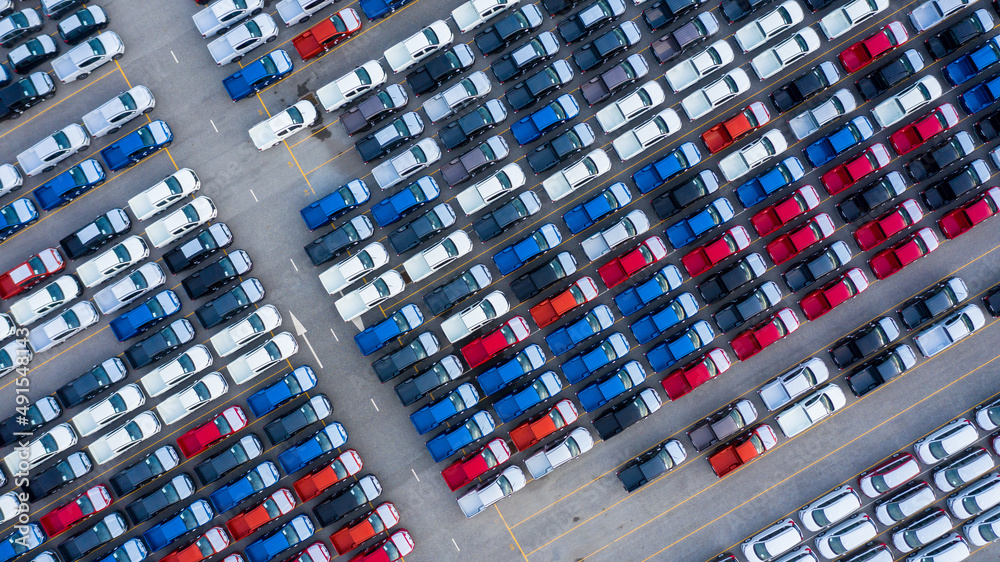 Aerial view new car lined up in the port for import and export business logistic to dealership for s