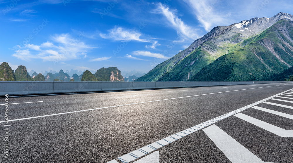 夏日蓝天下的沥青公路与山地自然风光