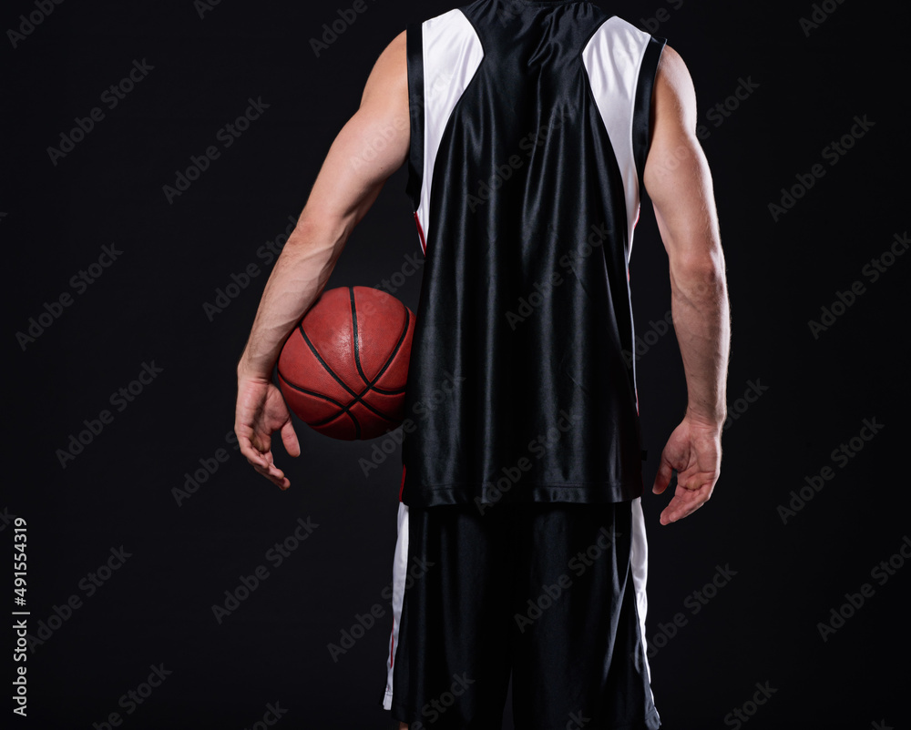 Winners never quit and quitters never win. Cropped rearview of a basketball player holding a basketb