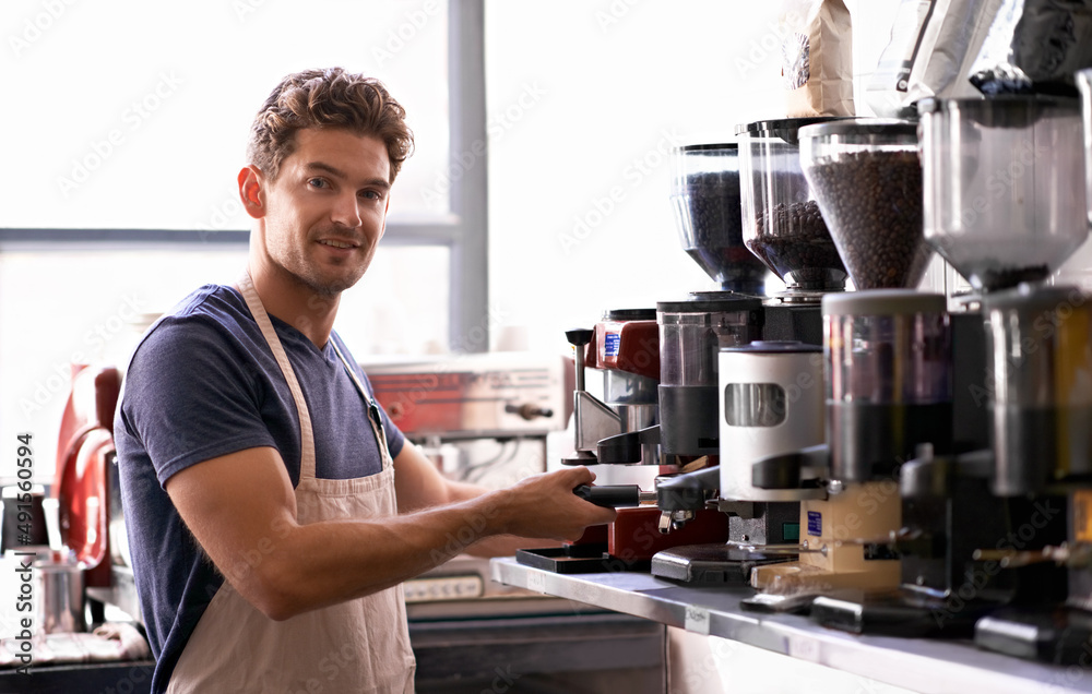 You name the blend and hell make it. Portrait of a young male barista in a coffee shop.