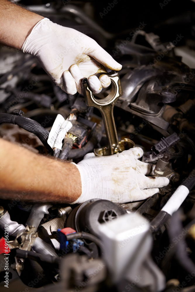 Your car is in good hands. Cropped image of a male mechanics hands about to check the oil of a car.