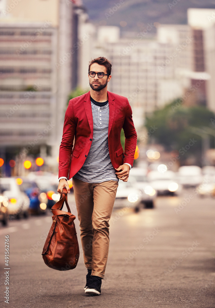 Styled for the city. Shot of a handsome young man taking a walk through the city.