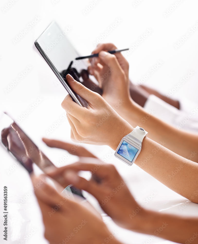 Synced with the times. A row of hands using digital devices.