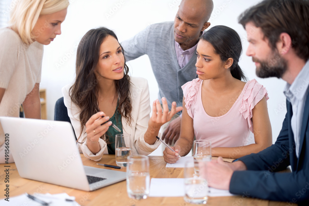 Working together. Shot of a group of business people in the middle of a discussion.