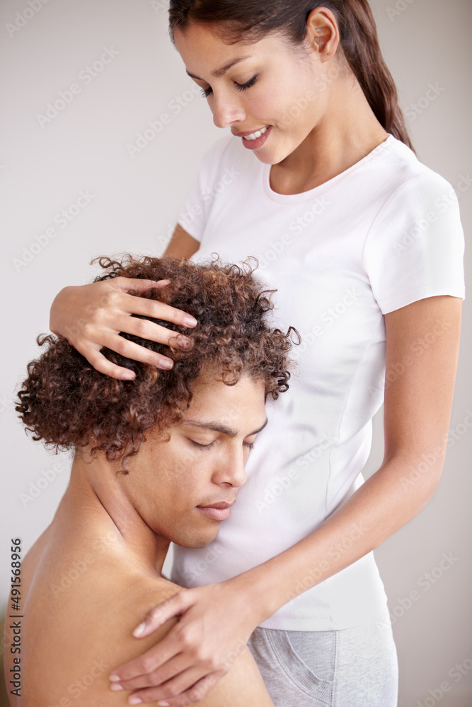 Hes the only one for me. A young ethnic couple holding each other gently with the mans head resting 