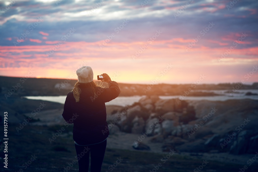 The beauty of nature is everywhere, I must capture it. Shot of an unrecognizable woman taking a pict