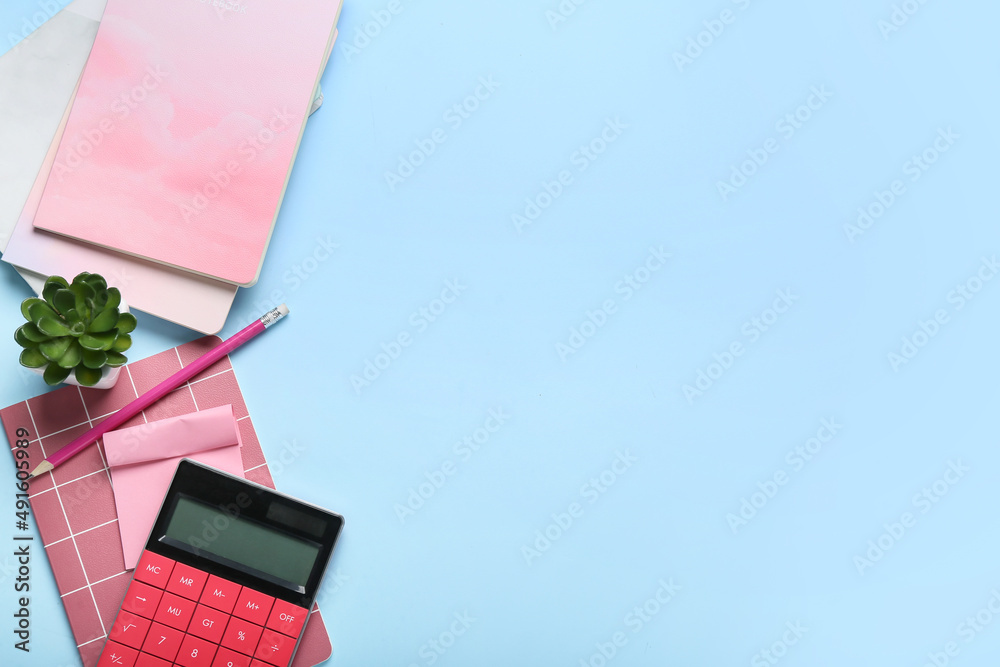 Composition with notebooks, calculator and pencil on color background