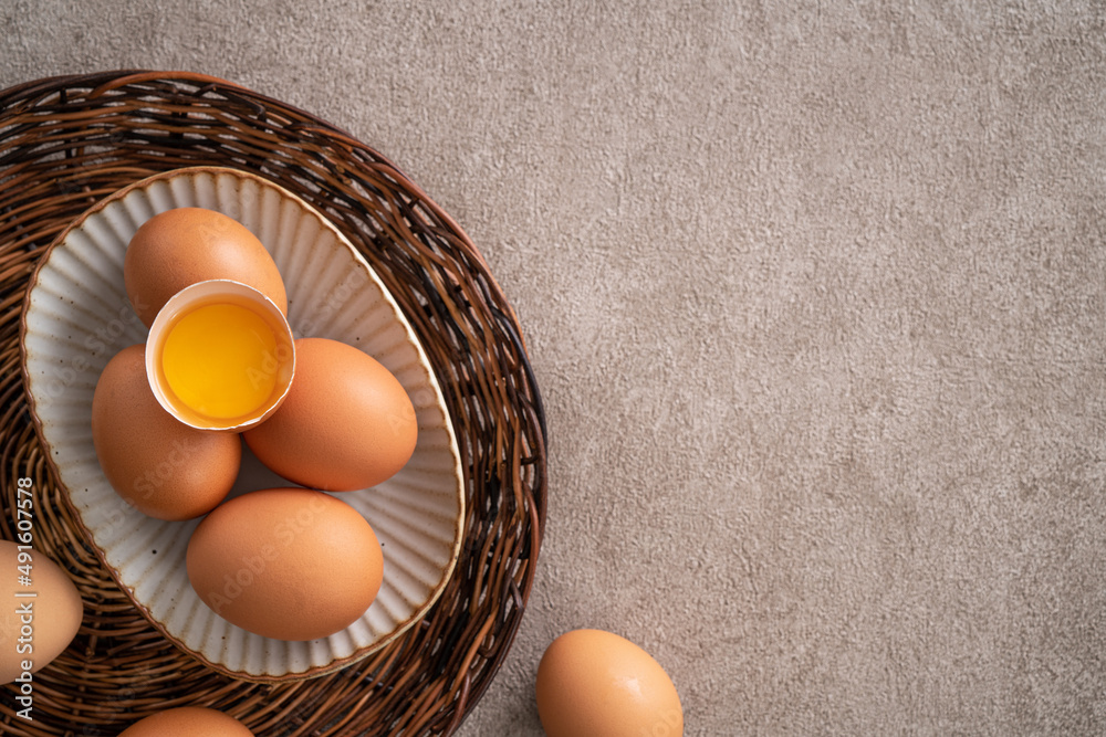 Fresh brown chicken eggs in a plate.