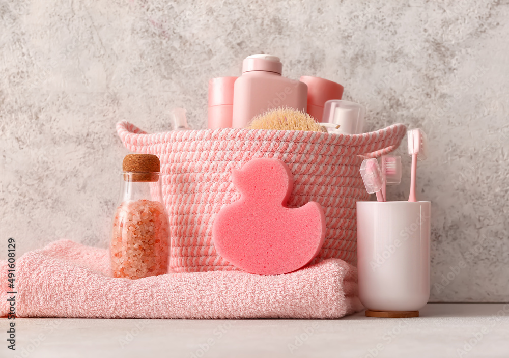 Set of different bath supplies and sponge on light background