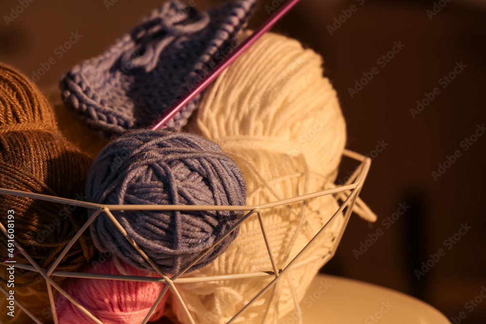 Basket with different knitting yarn and needles, closeup