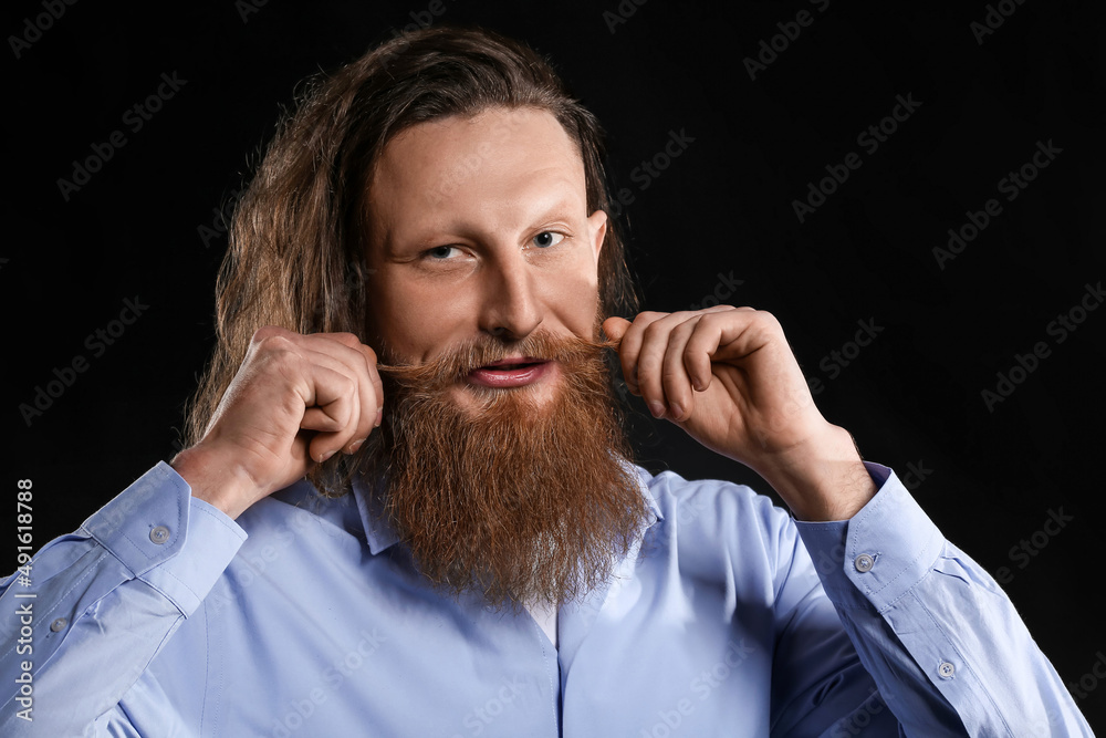 Portrait of handsome bearded man on dark background