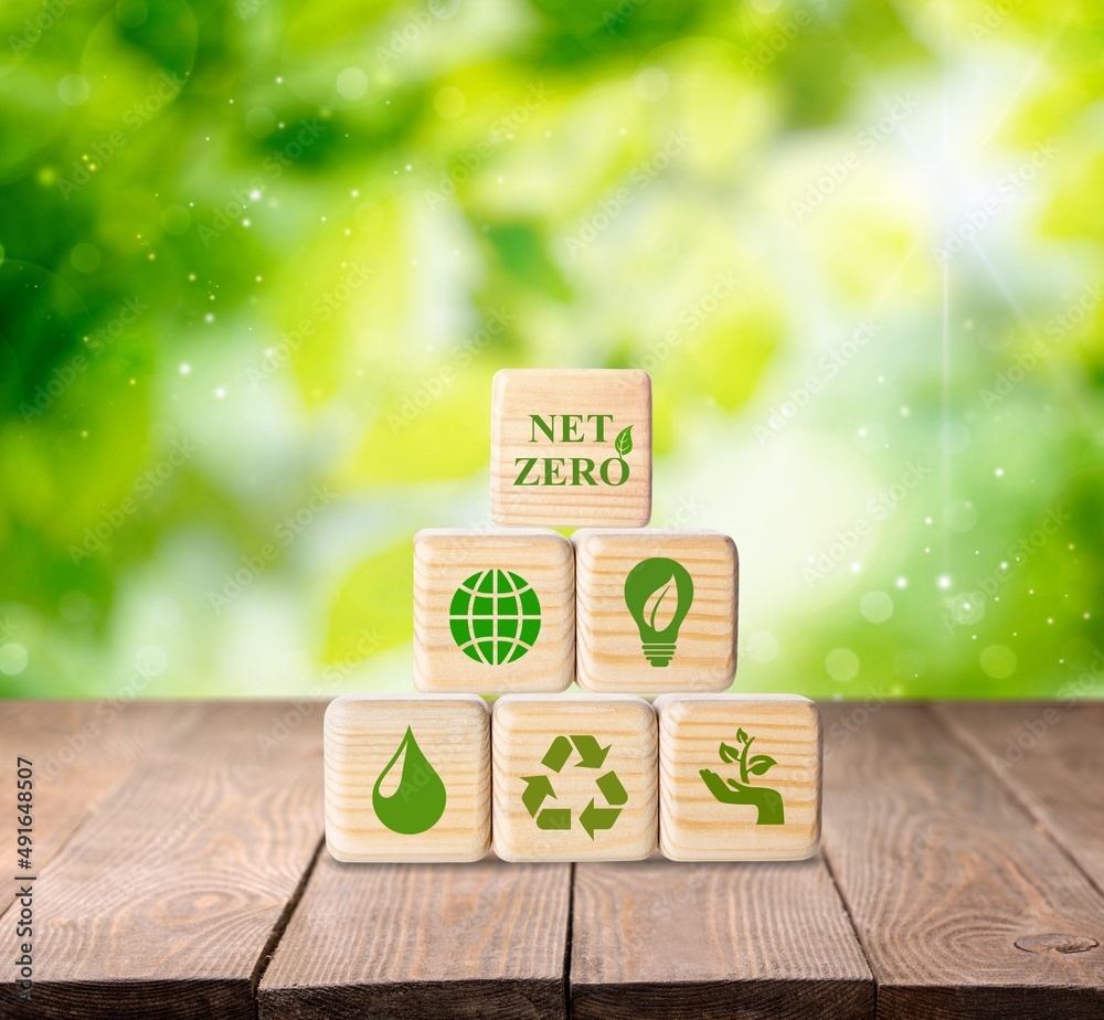 Net zero and carbon neutral concept. Put wooden cubes with green net zero icon