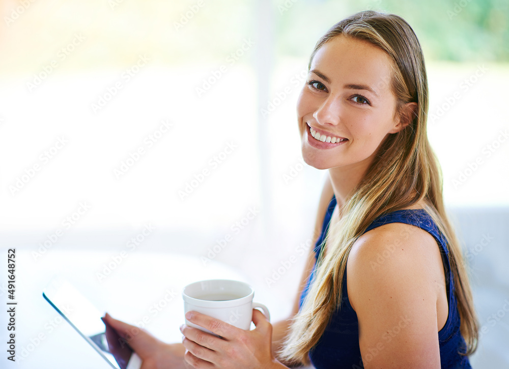 I have all the company I need right here..... Shot of a young woman using her digital tablet while h