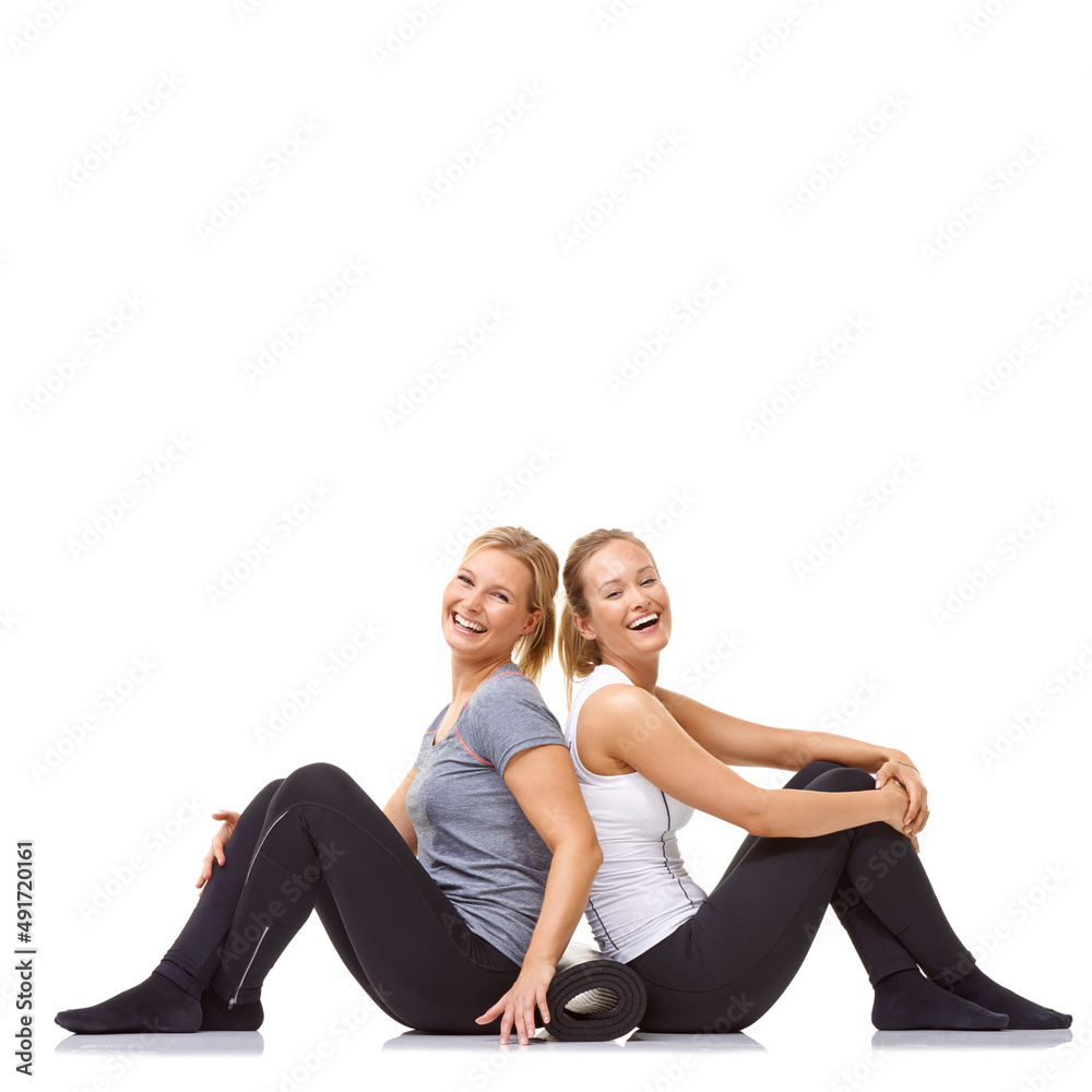 Taking the fitness journey together. Two gym friends sitting back to back while isolated on a white 