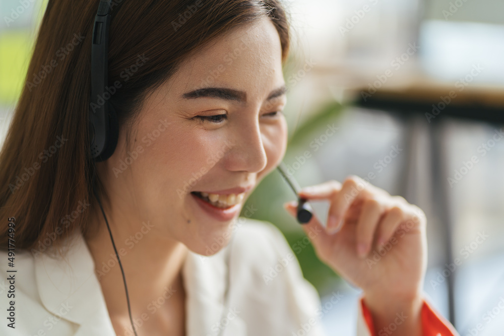 Call center business woman talking on headset. Caucasian female in customer service position talking